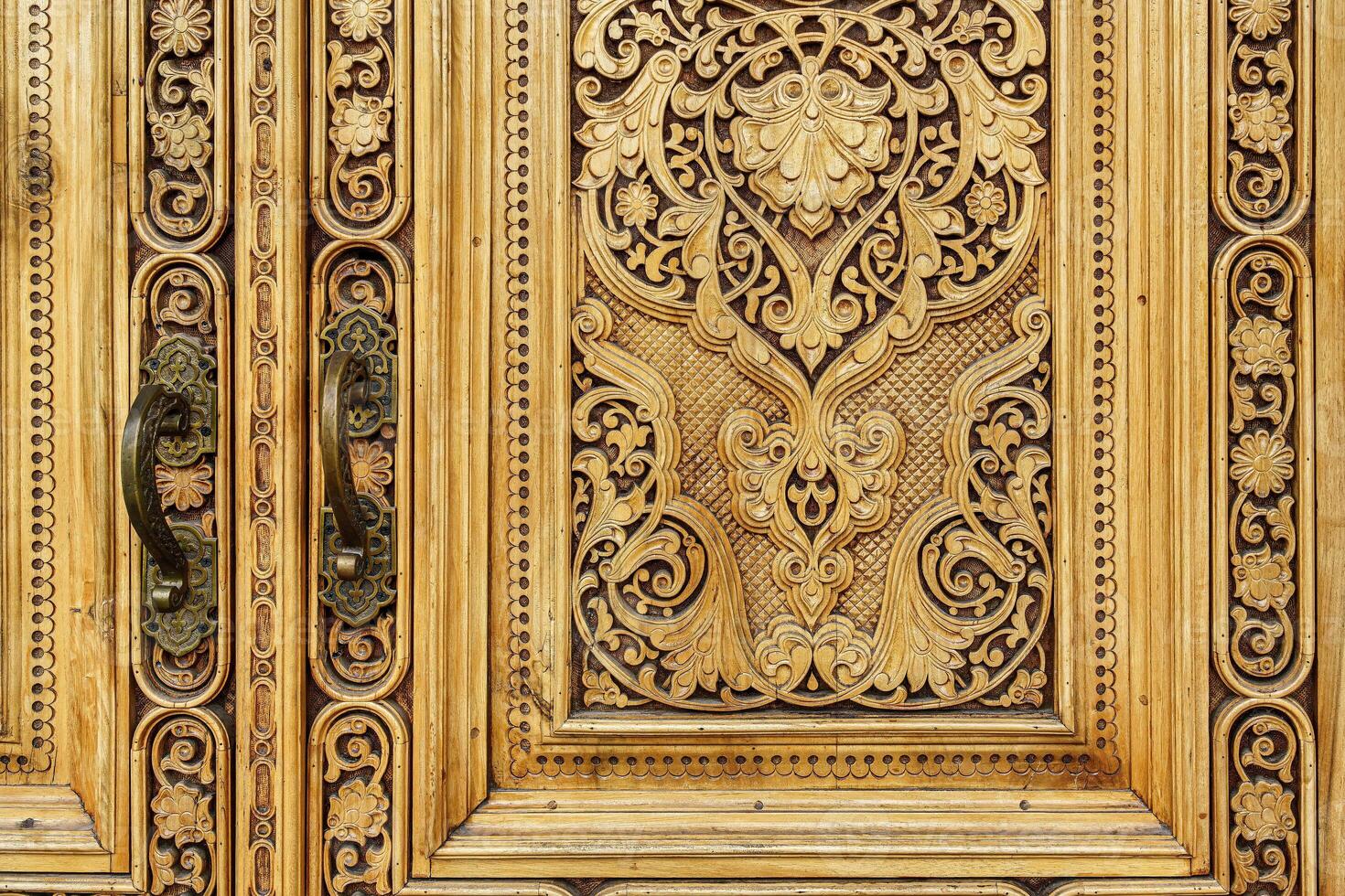 Fragment of an ancient carved wooden door. Ornate. photo