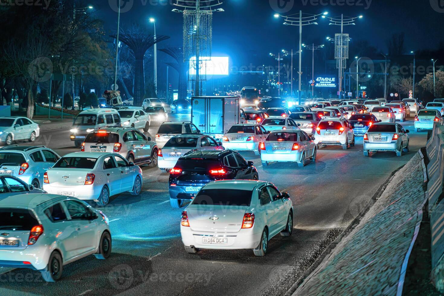 Blurred car traffic light at night city. Traffic jam in evening rush hour. photo