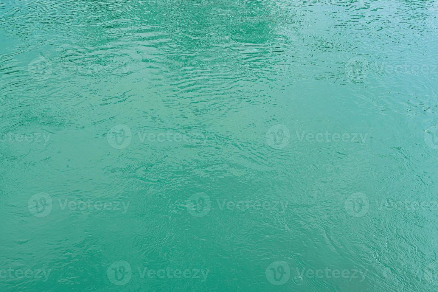 The texture of the waves of turquoise color of fast-flowing water in the river. photo