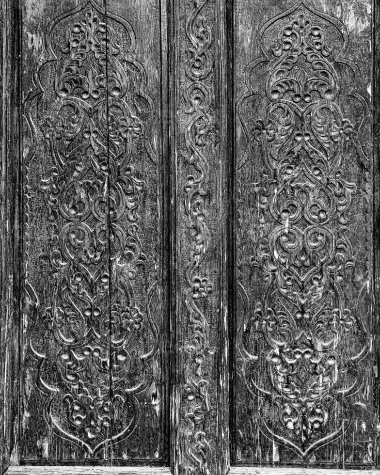 Carved wooden doors with patterns and mosaics. Abstract background for design. photo