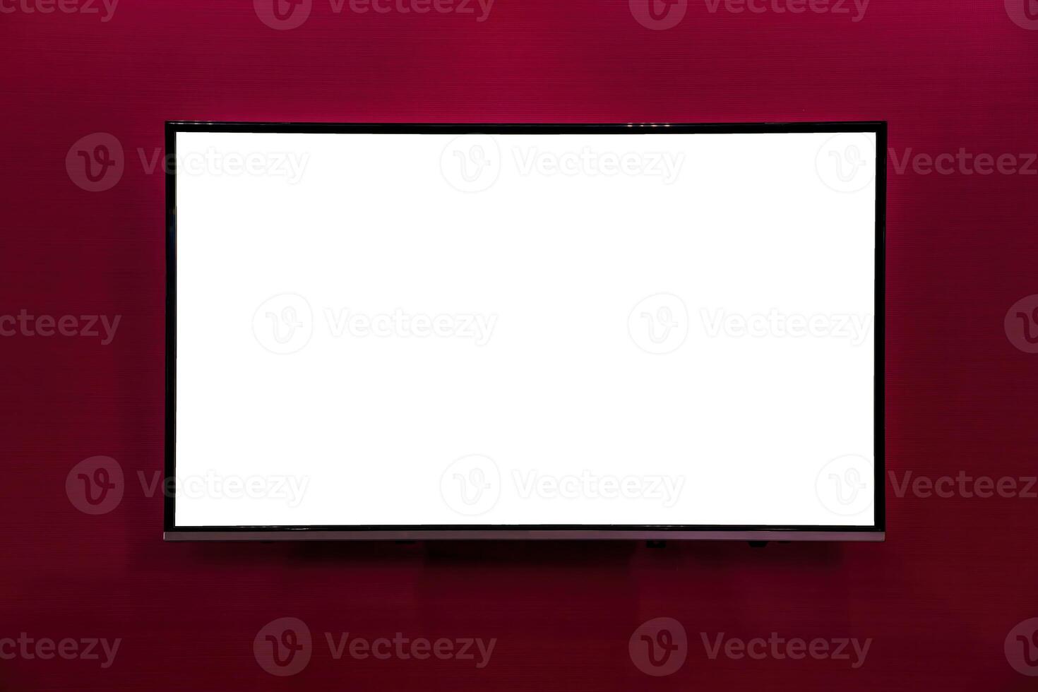 A monitor with copy space for text hanging on the wall with red wallpaper. Mockup for design. photo