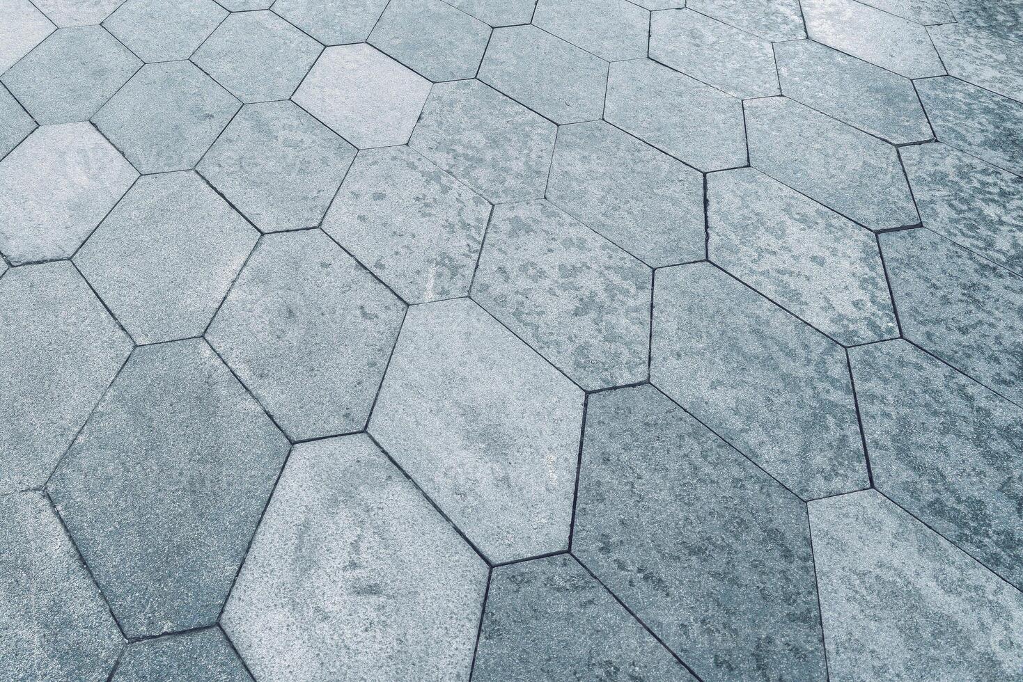 The texture of hexagonal tiled pavement with perspective. photo