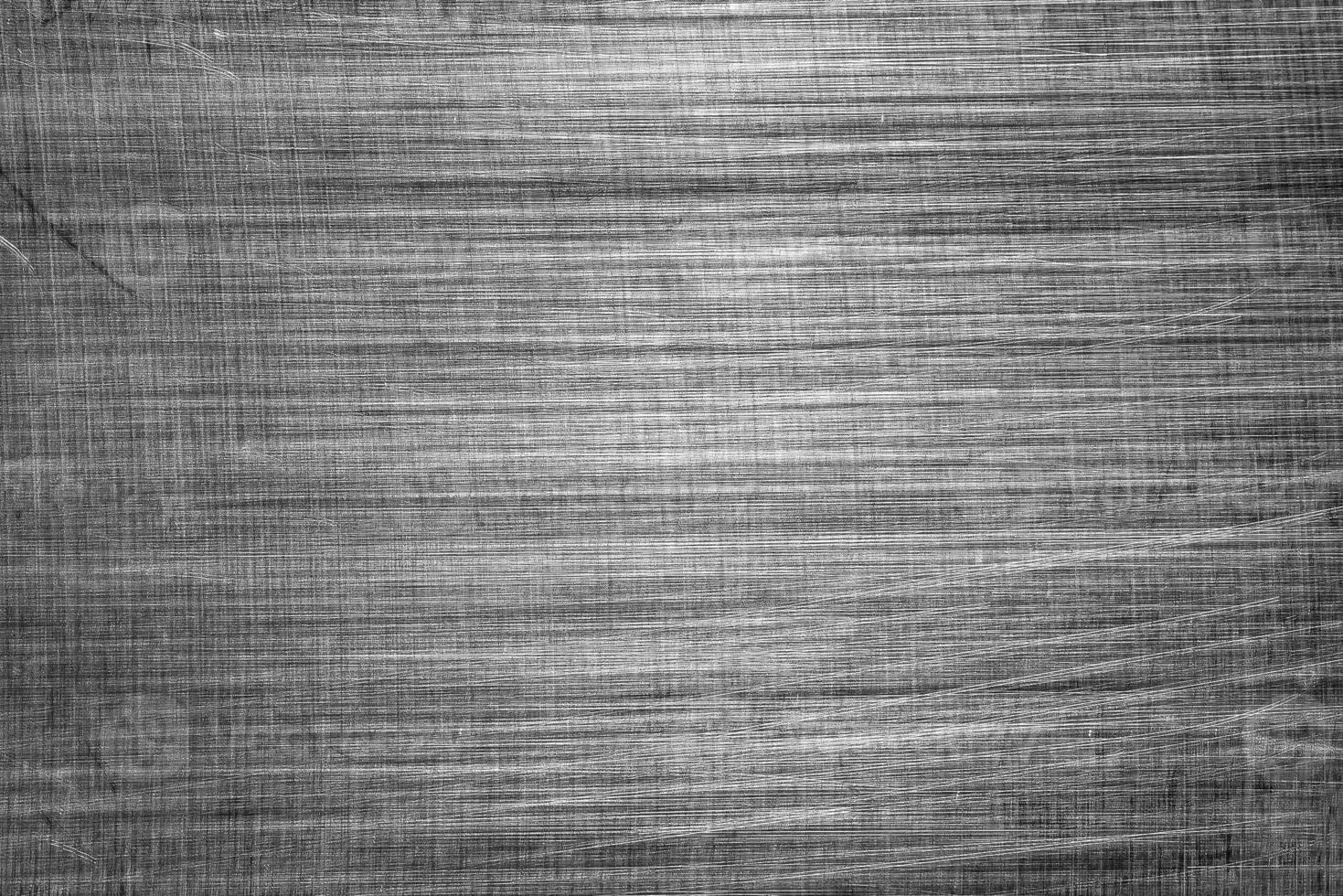 Monochrome texture of shiny scratched metal. Abstract background. photo