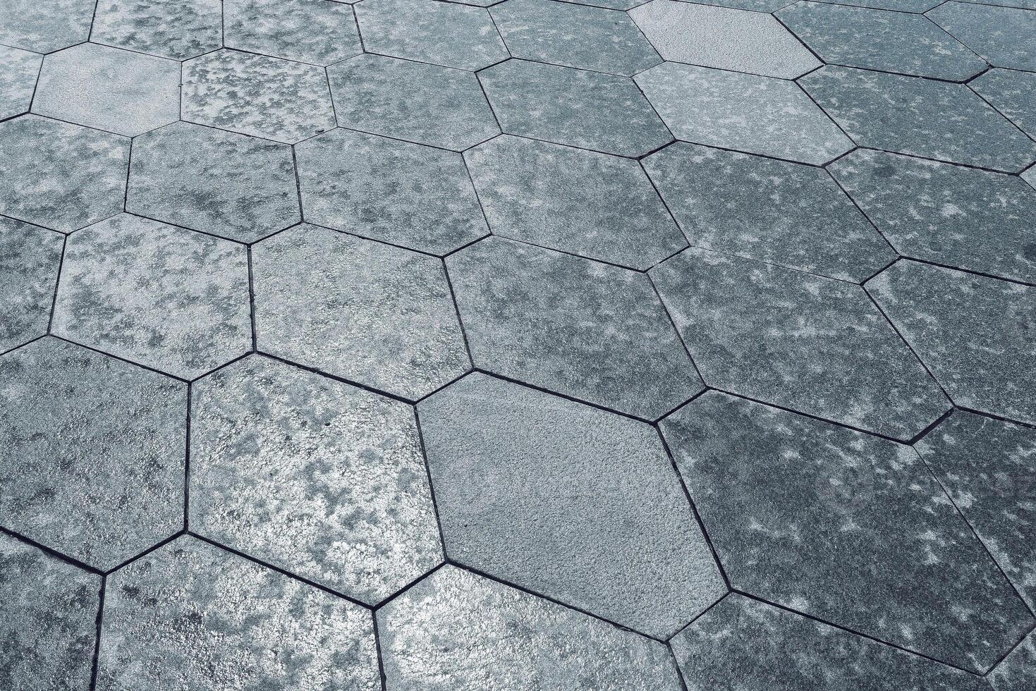 The texture of hexagonal tiled pavement with perspective. photo
