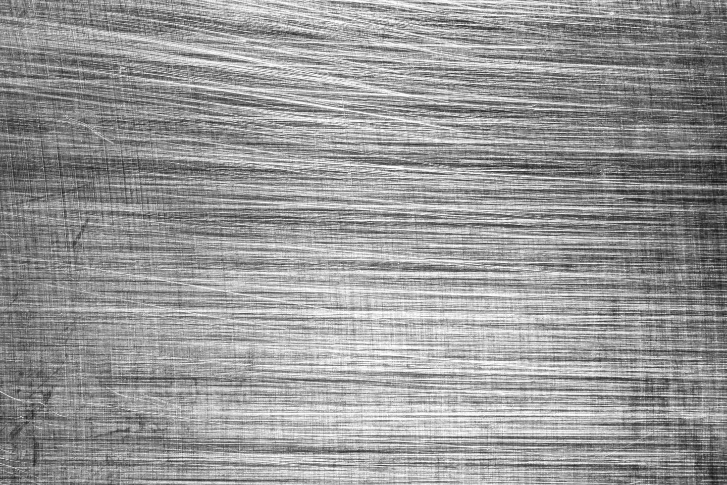 Monochrome texture of shiny scratched metal. Abstract background. photo