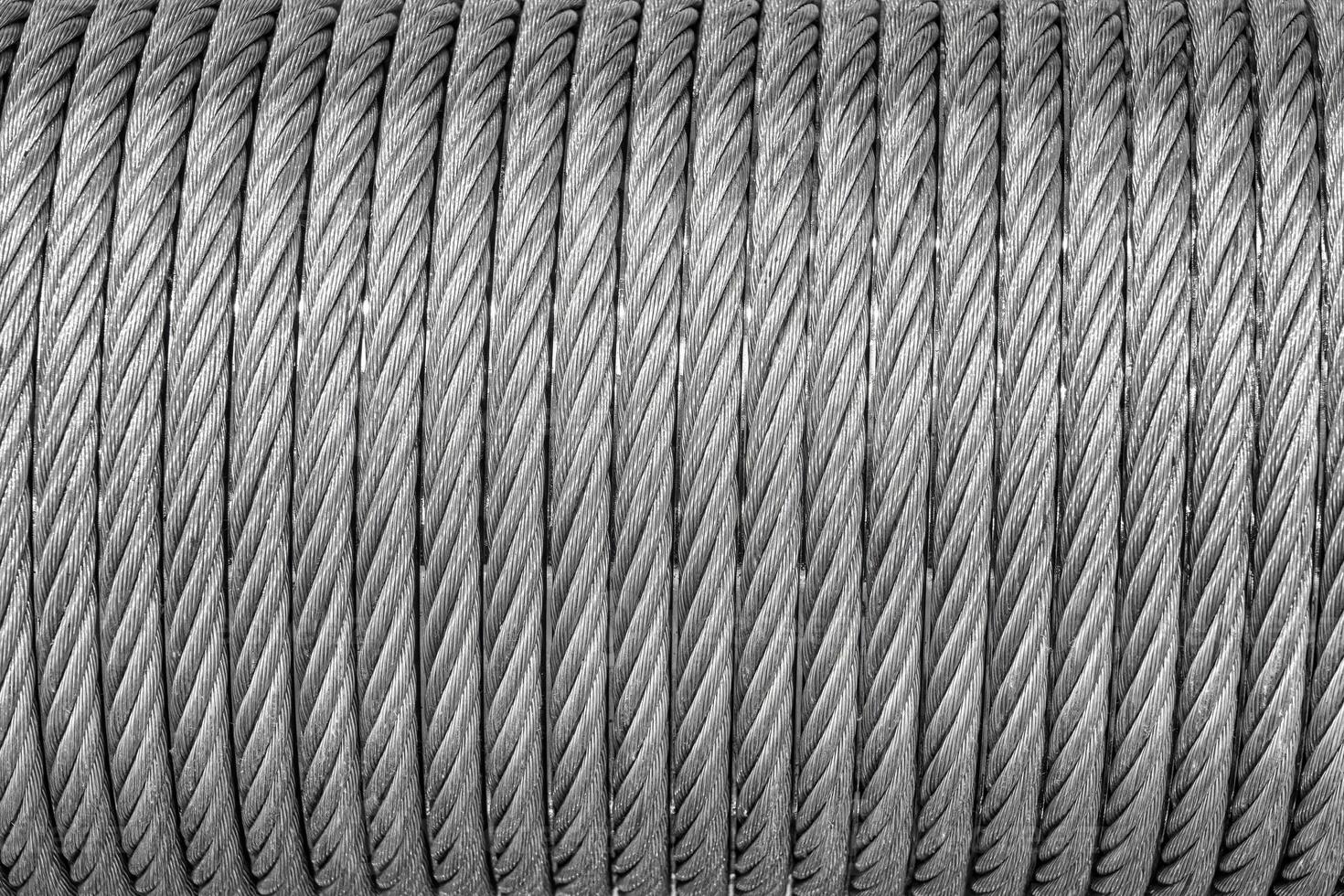 The texture of a new stainless steel cable wrapped in a spool. Abstract background. photo