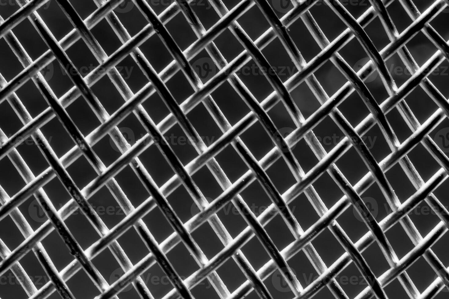 Monochrome texture of a shiny metal colander or grate. Abstract background. photo