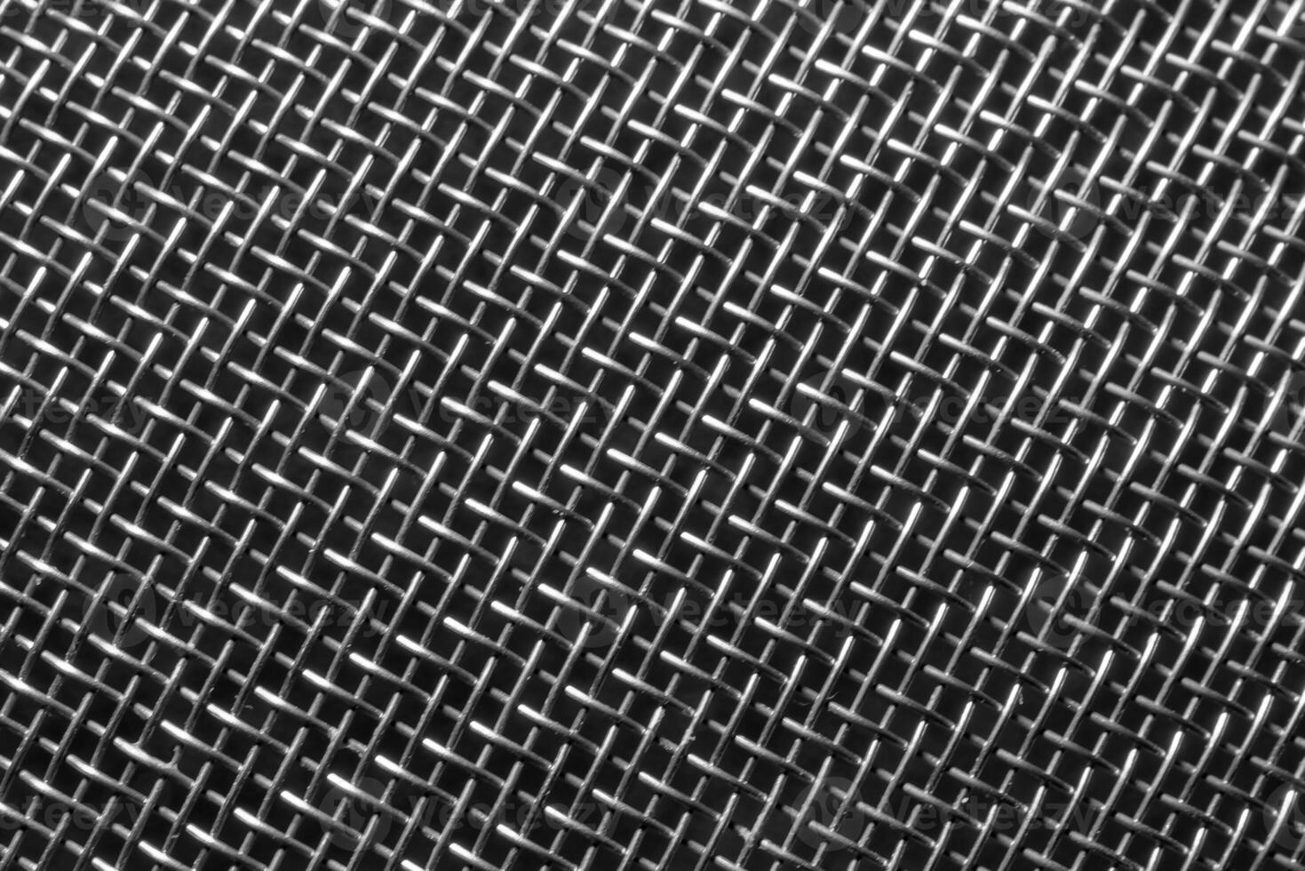 Monochrome texture of a shiny metal colander or grate. Abstract background. photo