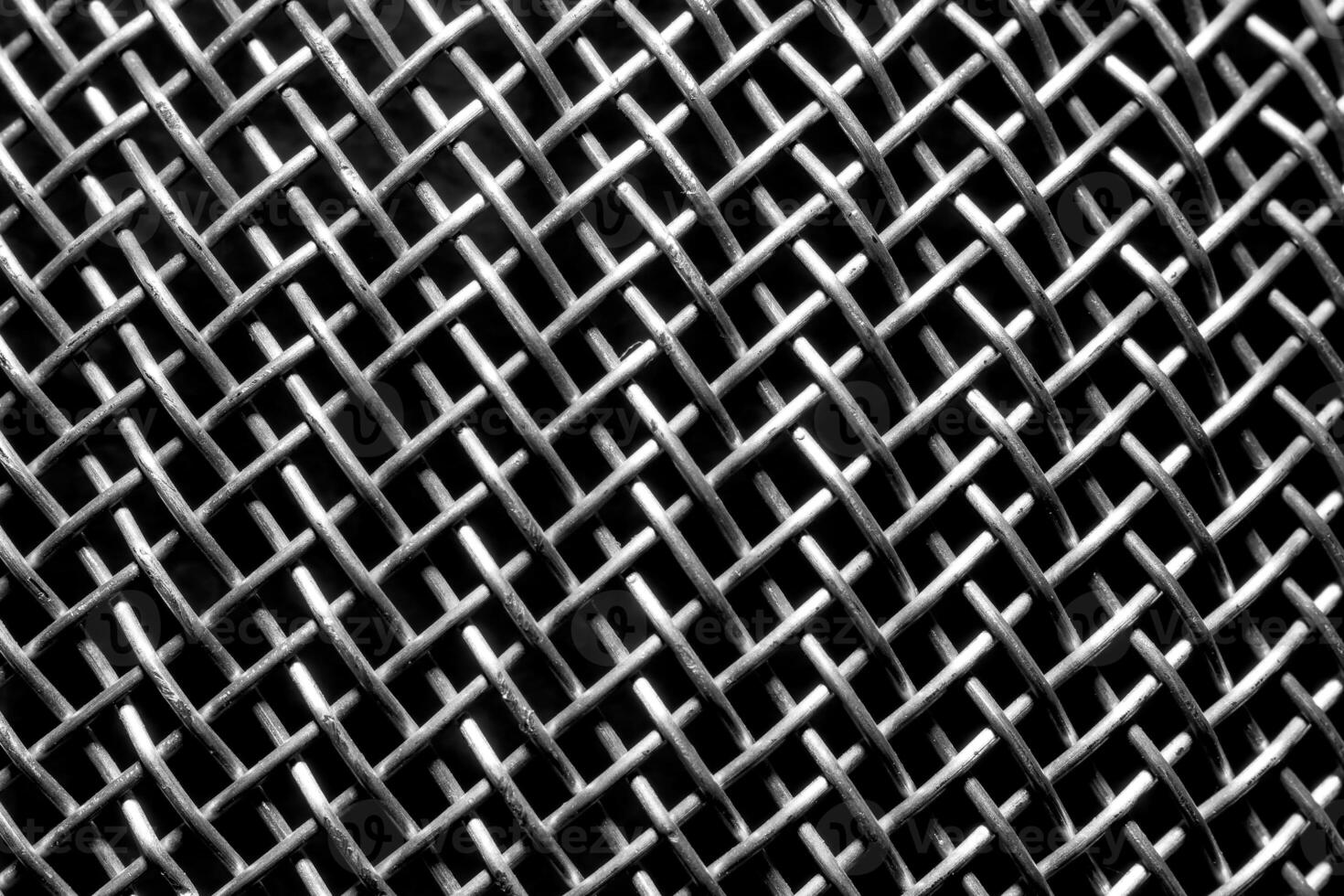 Monochrome texture of a shiny metal colander or grate. Abstract background. photo