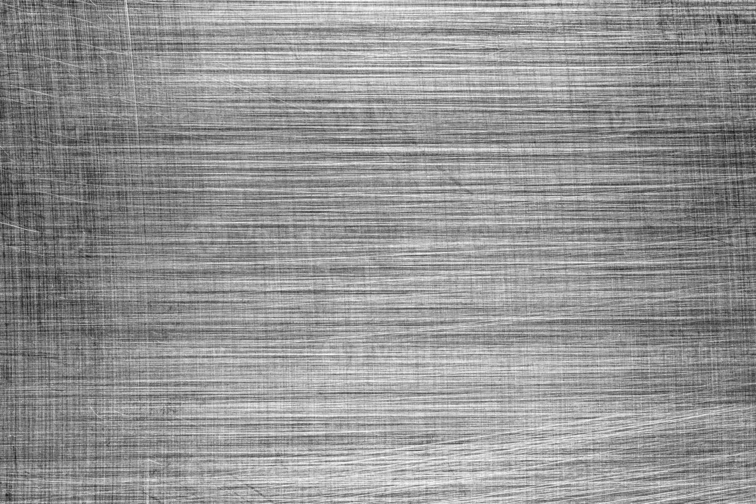 Monochrome texture of shiny scratched metal. Abstract background. photo