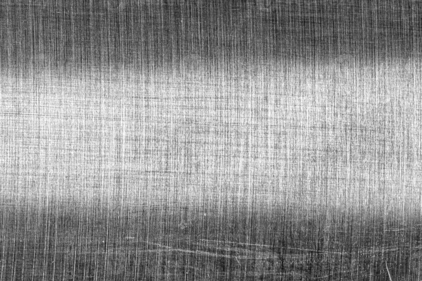 Monochrome texture of shiny scratched metal. Abstract background. photo