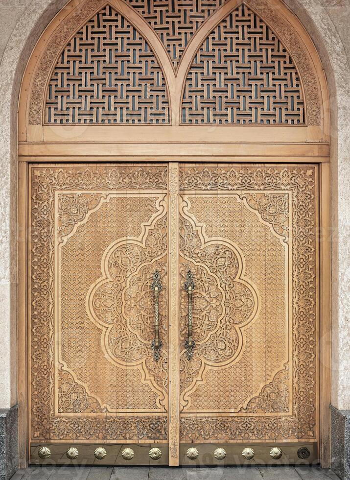 Carved wooden doors with patterns and mosaics. photo