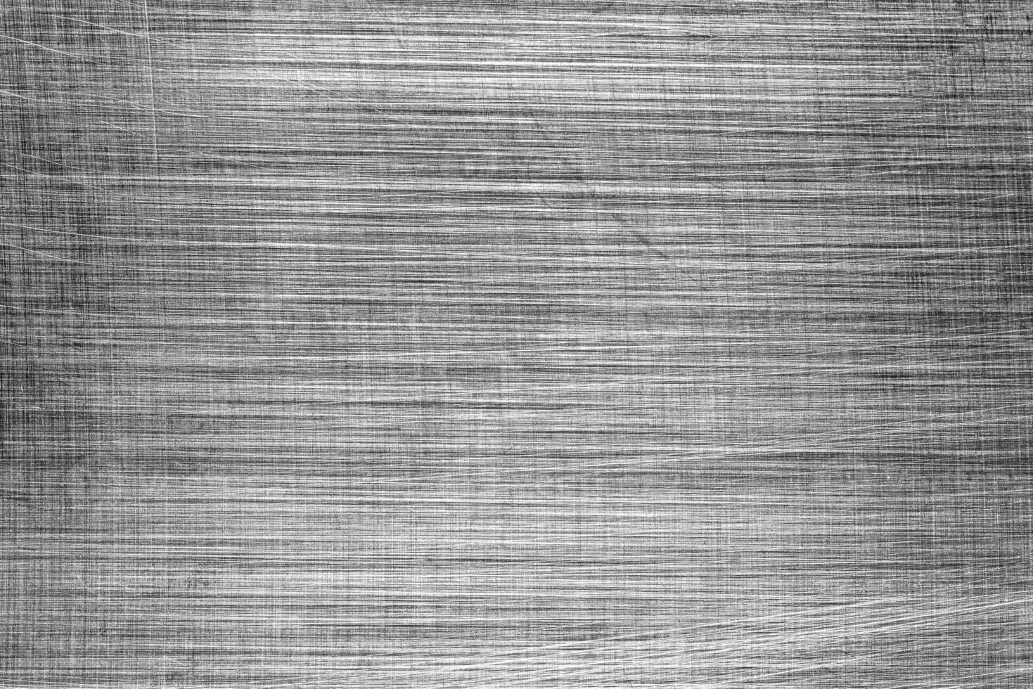 Monochrome texture of shiny scratched metal. Abstract background. photo