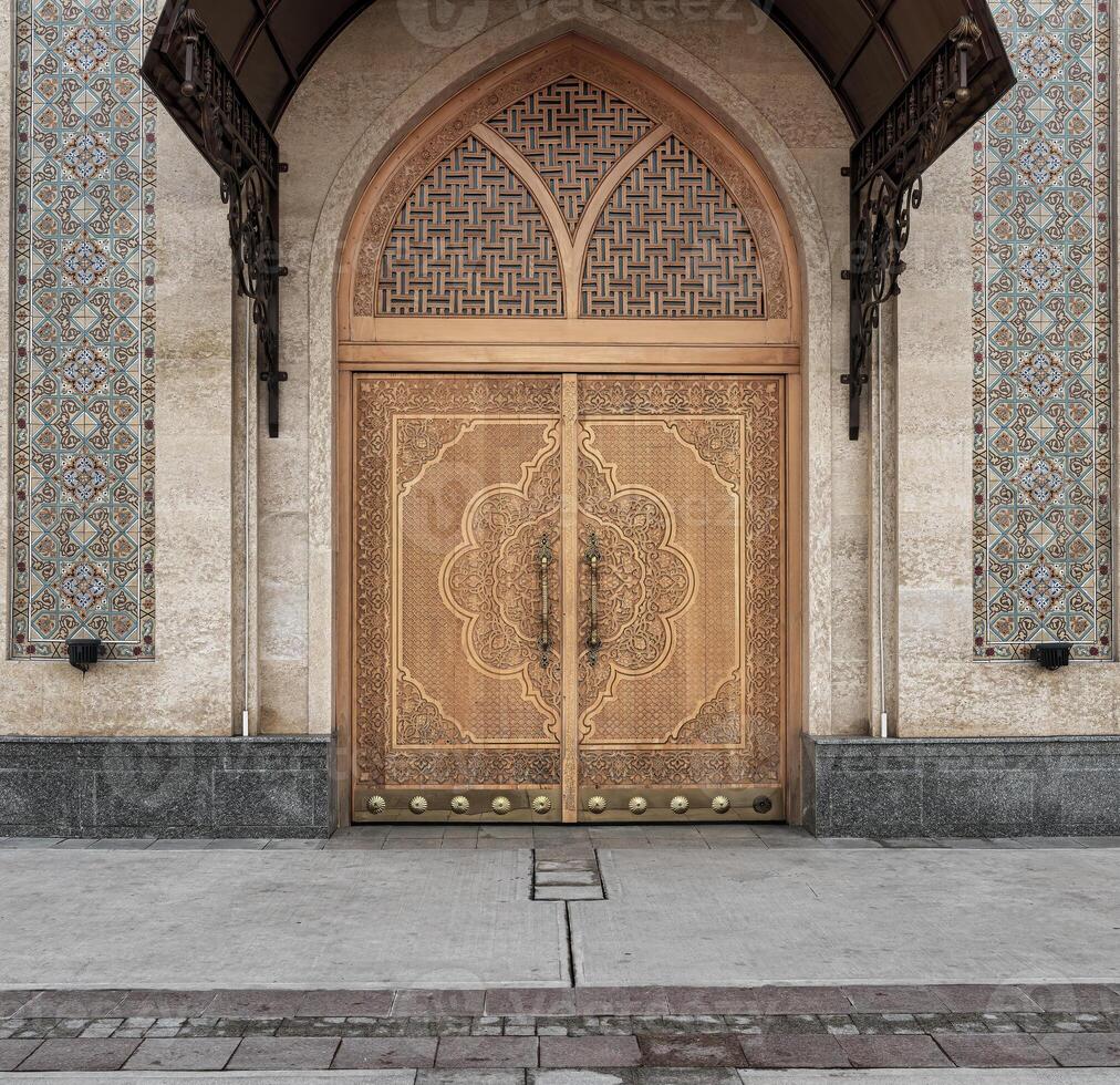 Carved wooden doors with patterns and mosaics. photo