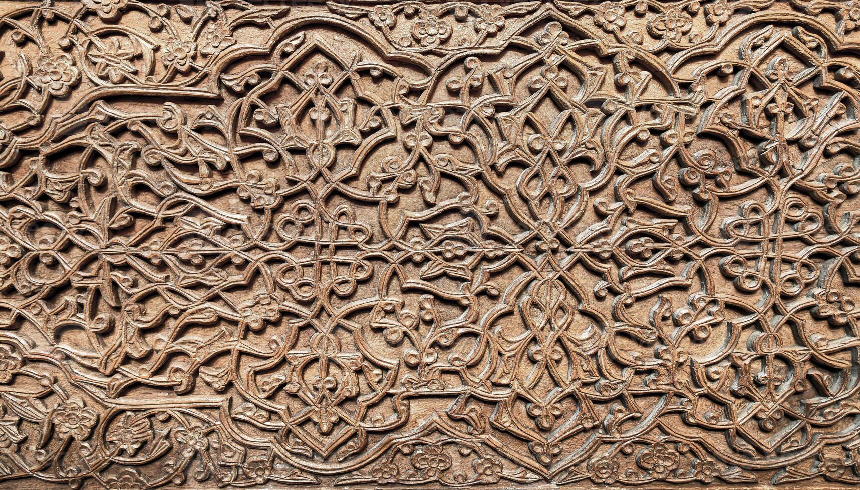 Fragment of an ancient carved wooden door. Ornate. photo