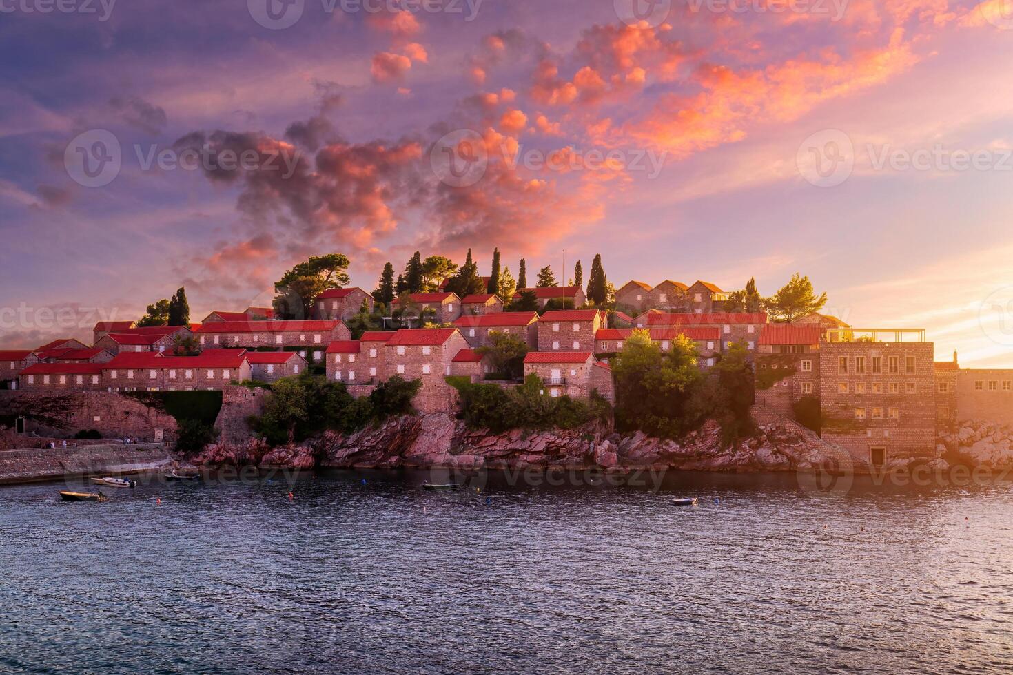 Hotel on the island of Sveti Stefan at sunset, Budva, Montenegro. photo