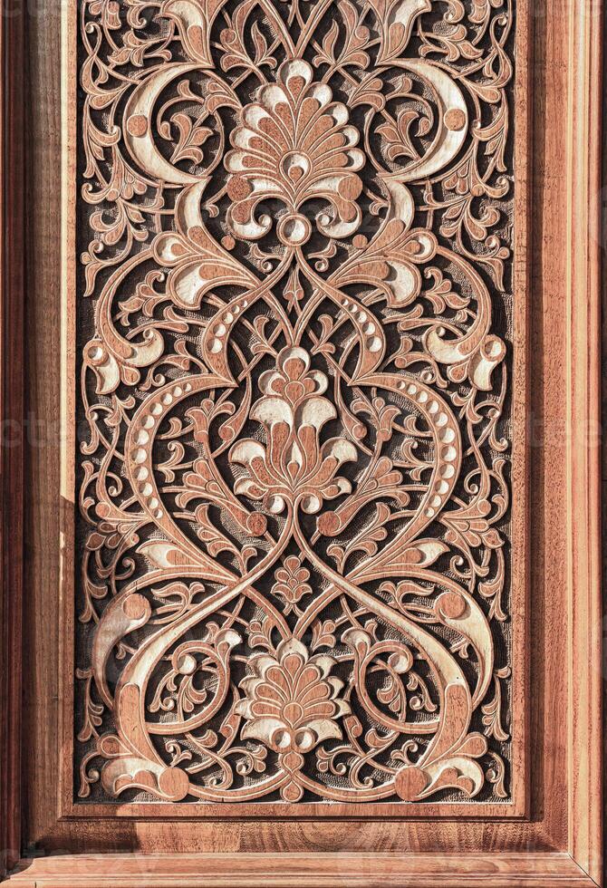 Fragment of an ancient carved wooden door. Ornate. photo