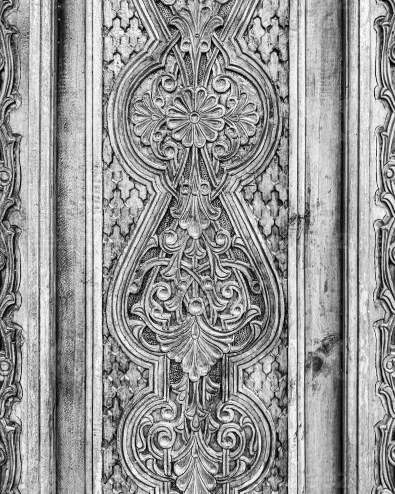 Carved wooden doors with patterns and mosaics. photo