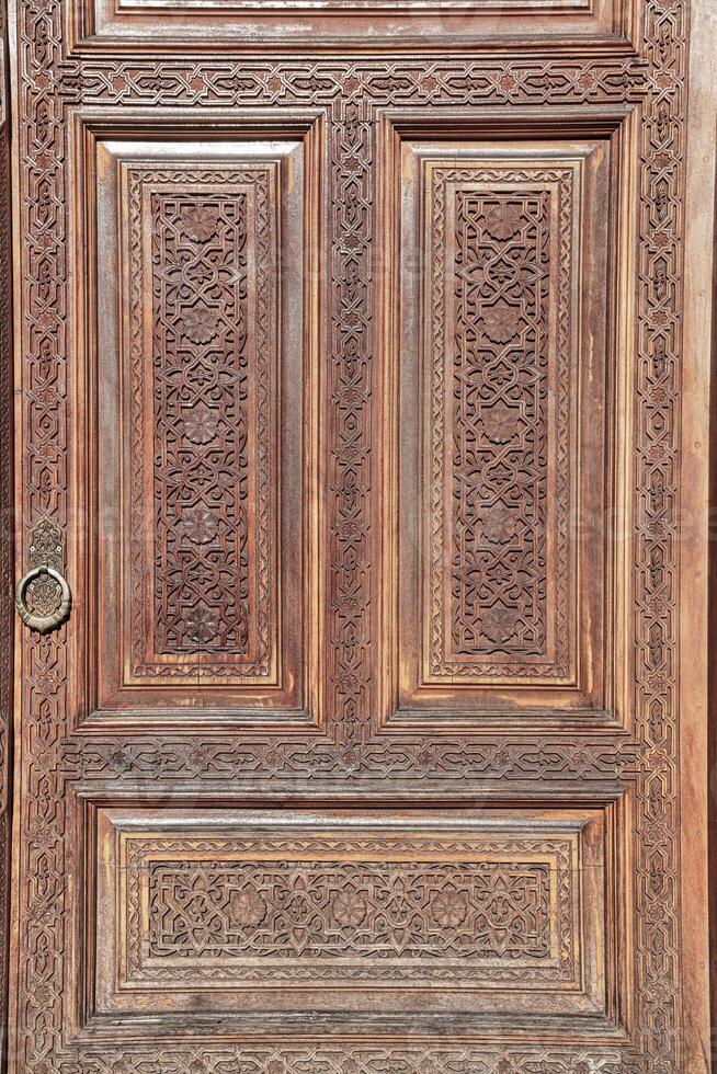 Carved wooden doors with patterns and mosaics. photo