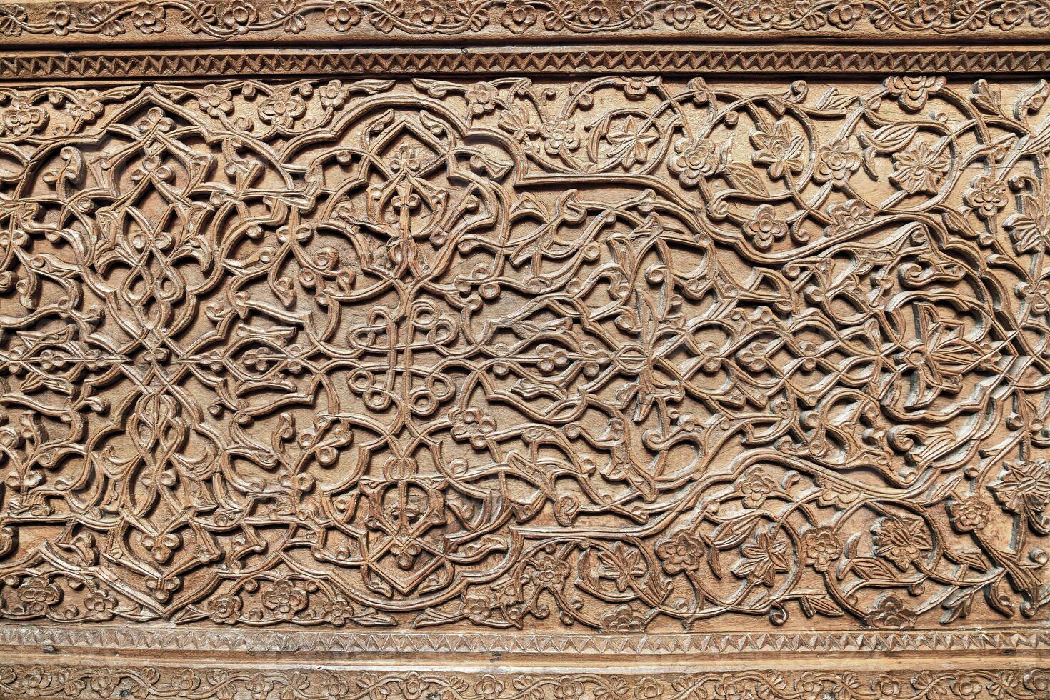 Fragment of an ancient carved wooden door. Ornate. photo