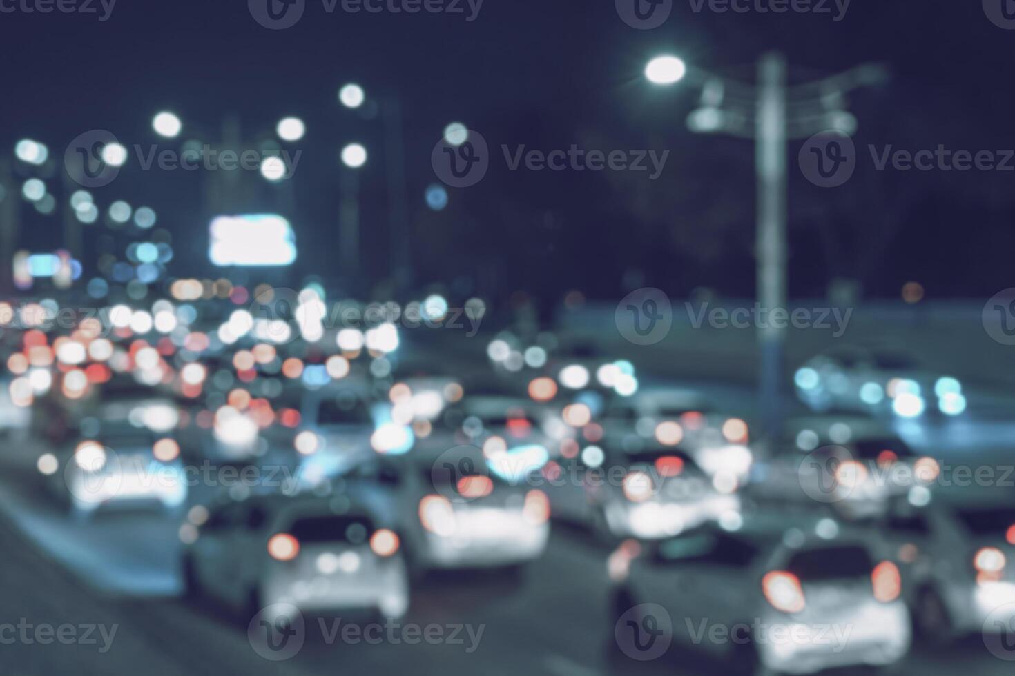 Blurred car traffic light at night city. Traffic jam in evening rush hour. photo