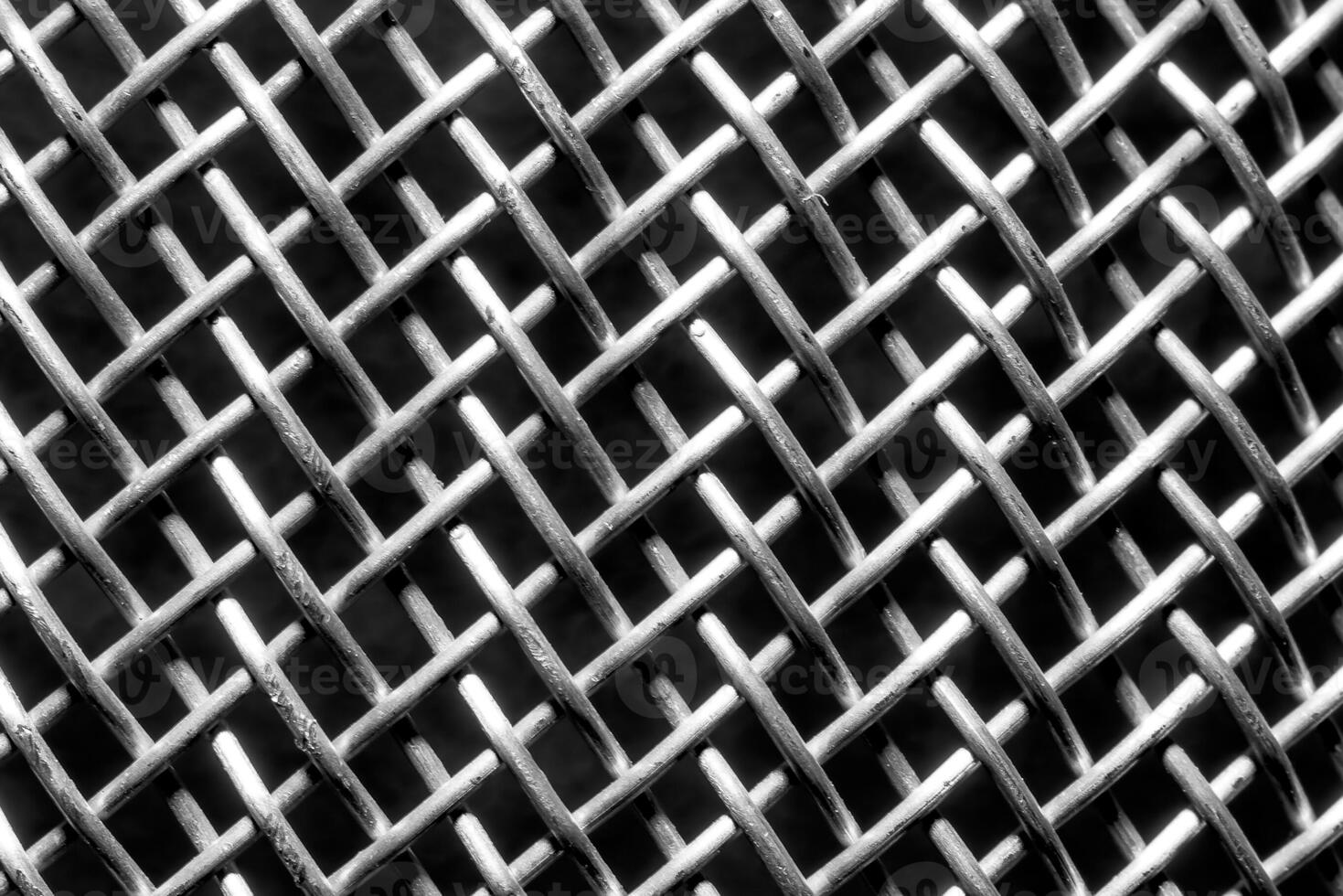 Monochrome texture of a shiny metal colander or grate. Abstract background. photo