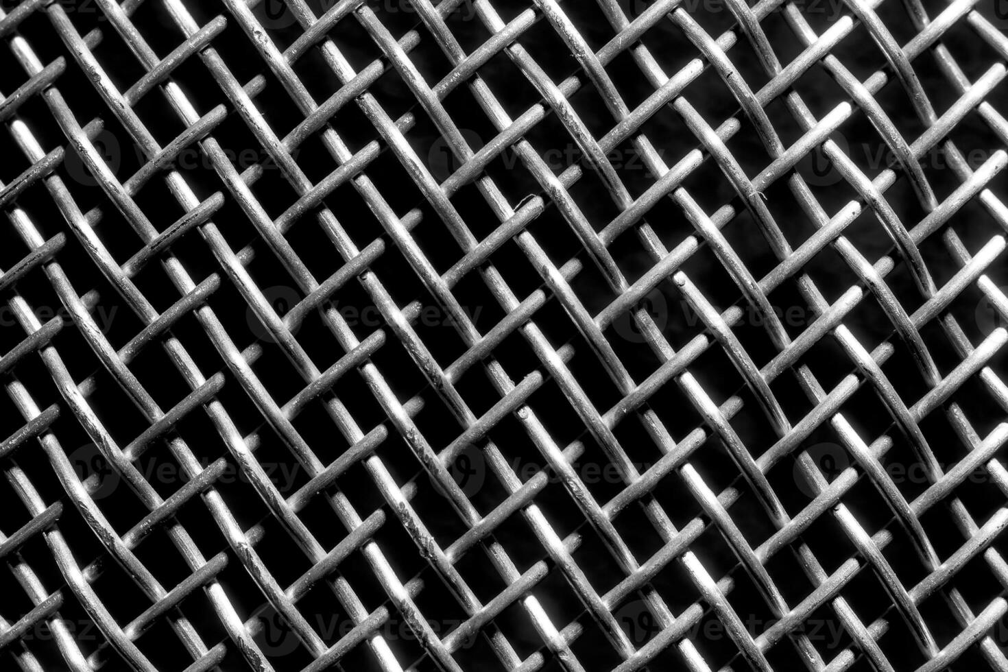 Monochrome texture of a shiny metal colander or grate. Abstract background. photo