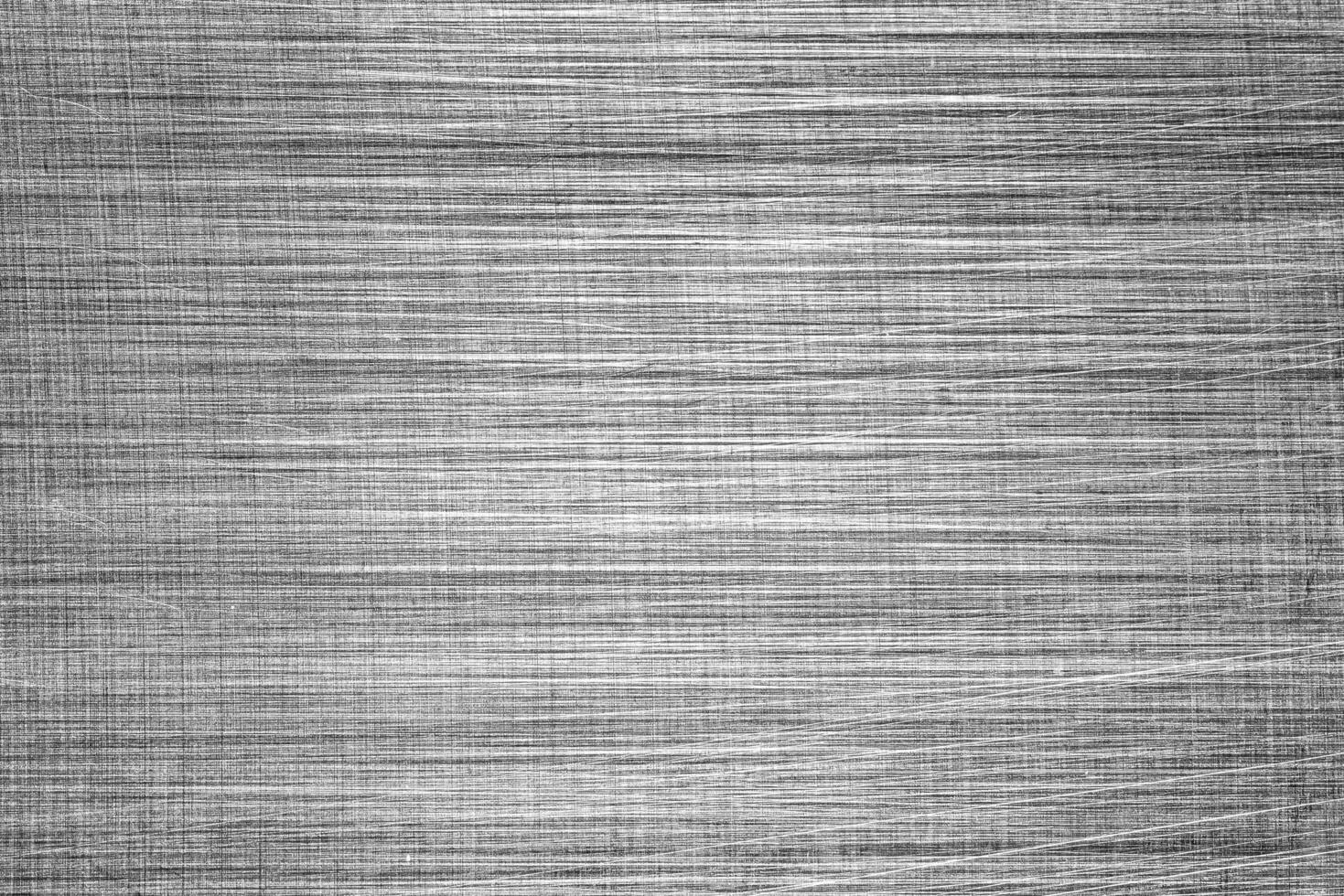 Monochrome texture of shiny scratched metal. Abstract background. photo