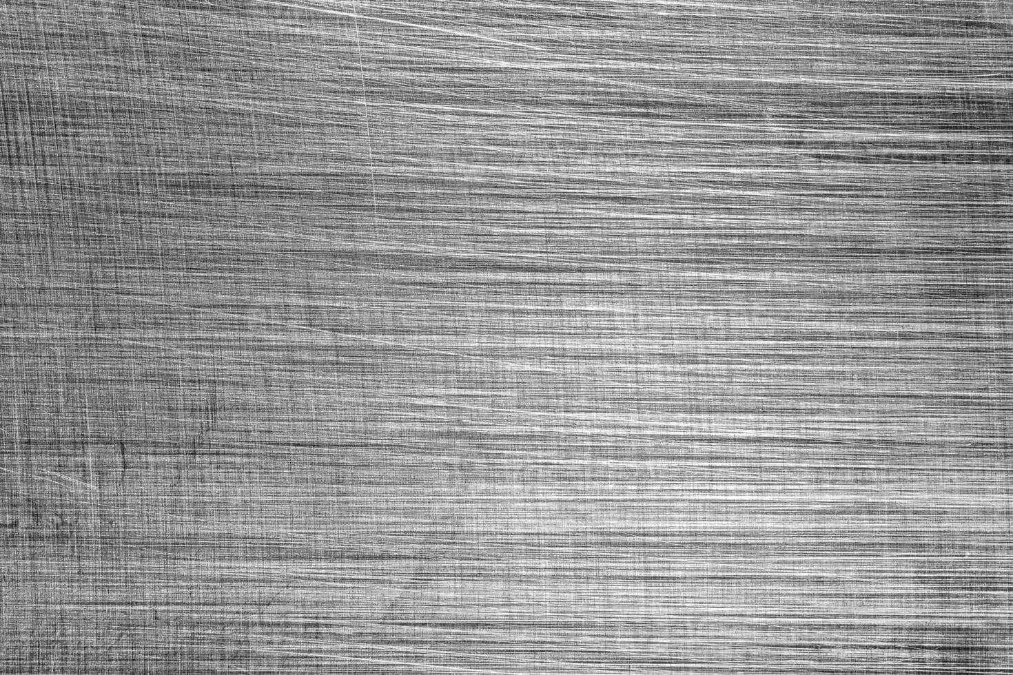 Monochrome texture of shiny scratched metal. Abstract background. photo