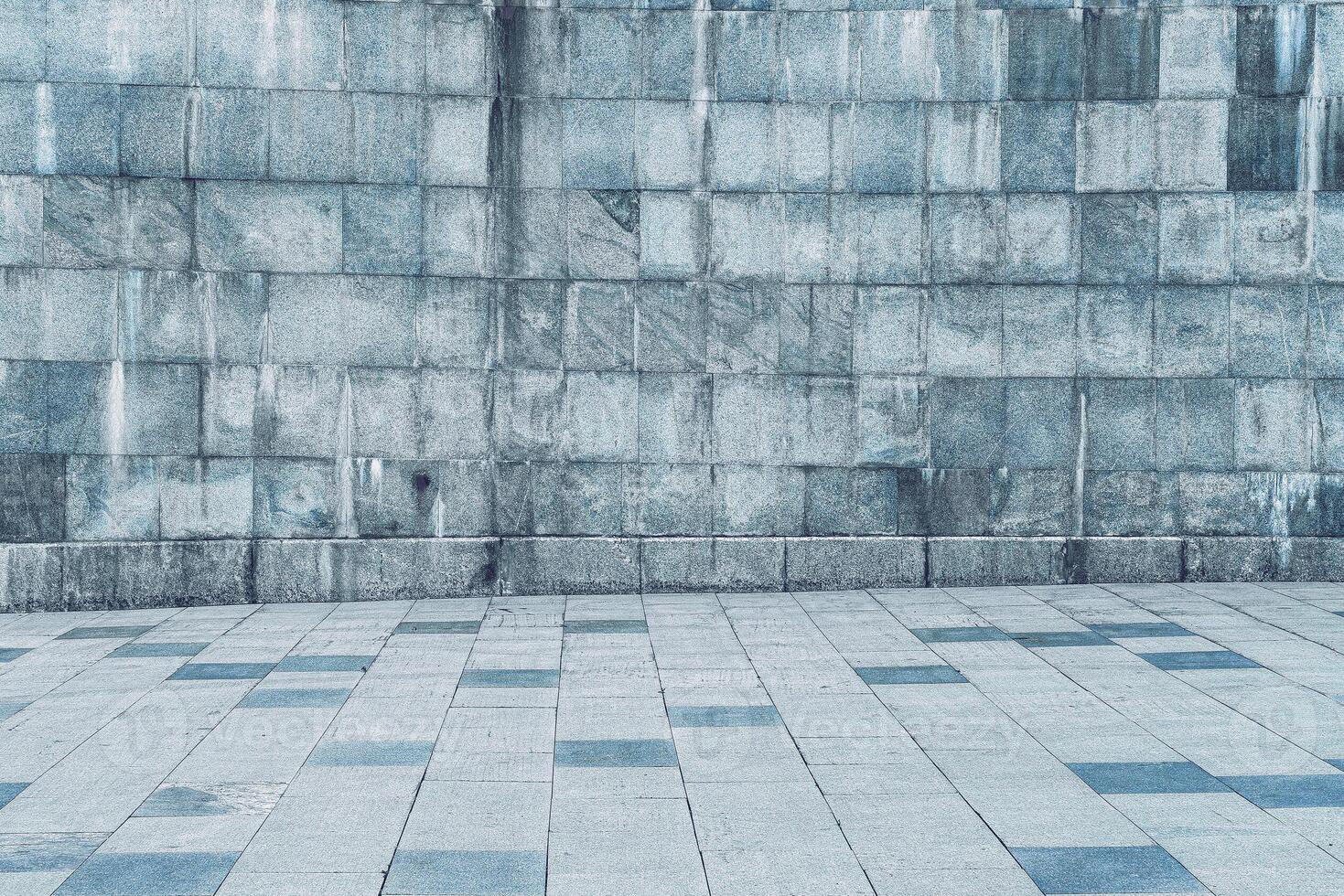 Texture of stone wall covered with tiles and pavement. photo