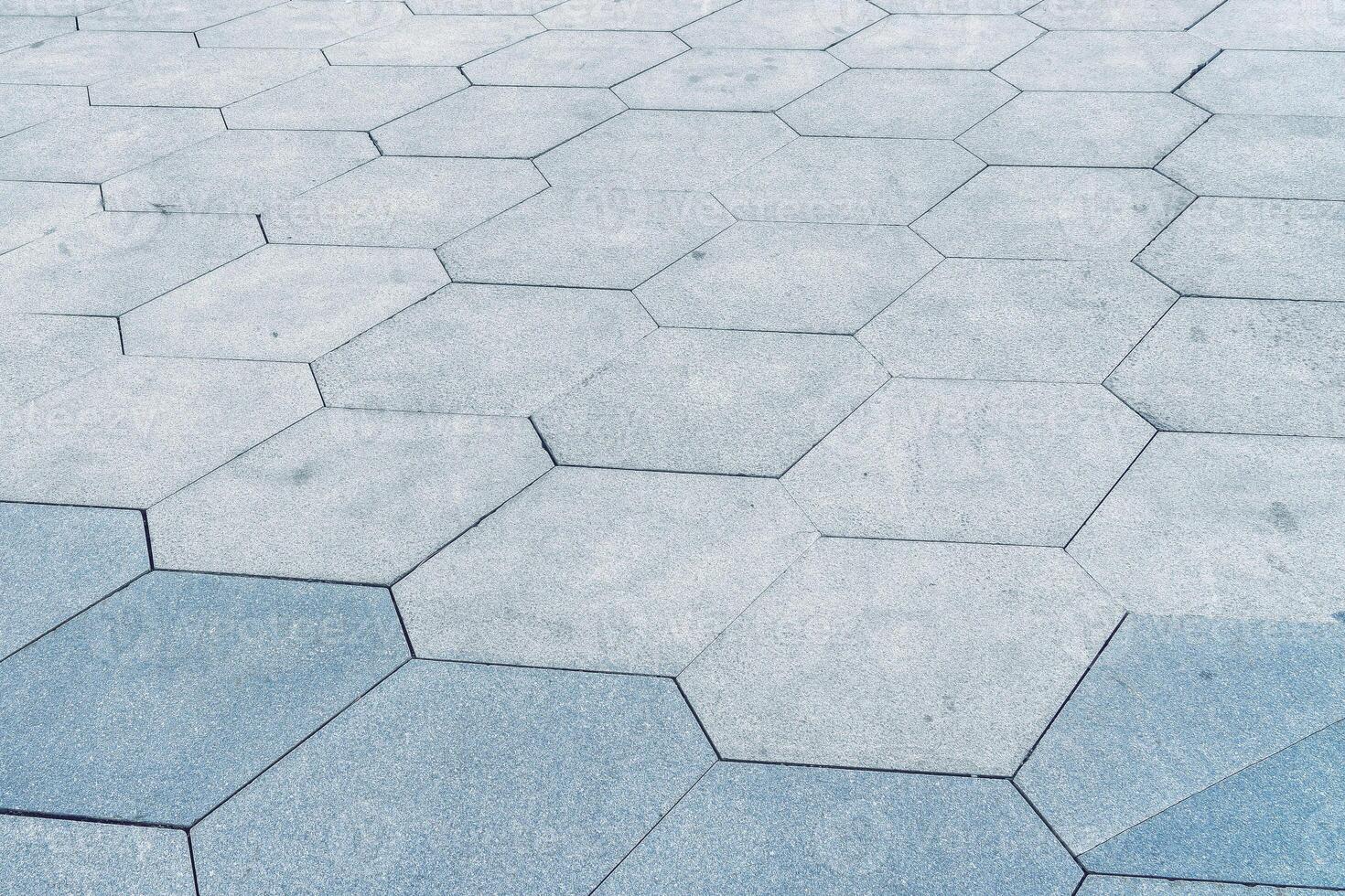 The texture of hexagonal tiled pavement with perspective. photo