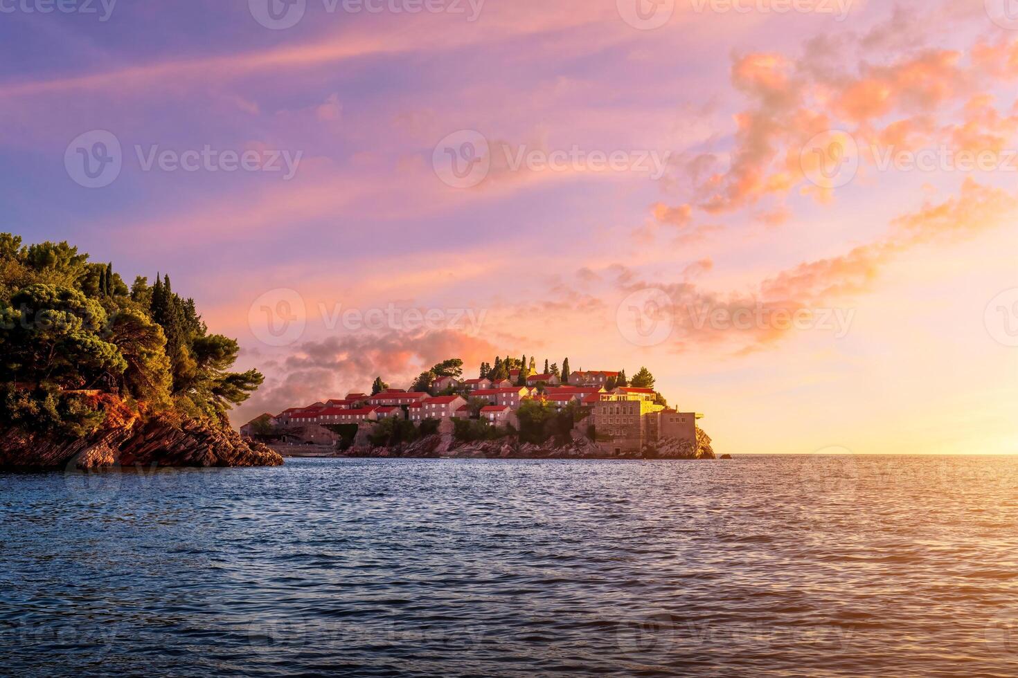 Hotel on the island of Sveti Stefan at sunset, Budva, Montenegro. photo