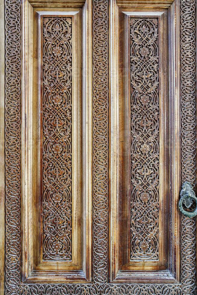 Carved wooden doors with patterns and mosaics. photo