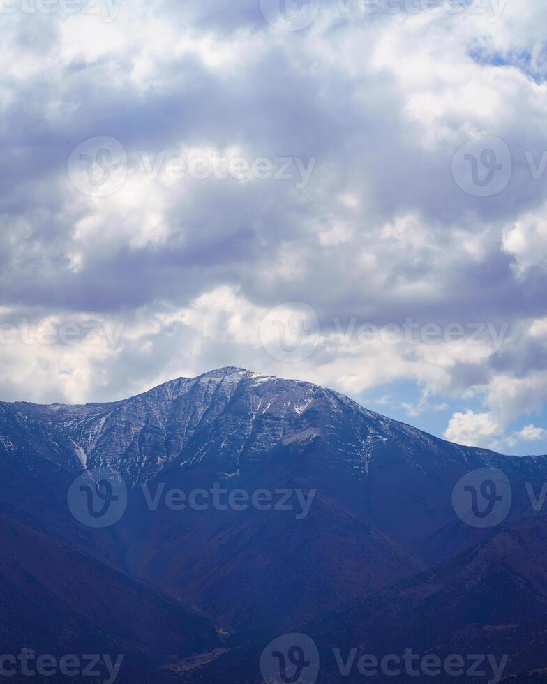 Mountain top covered with young snow and illuminated by the sun on a sunny day in Zaamin reserve. photo