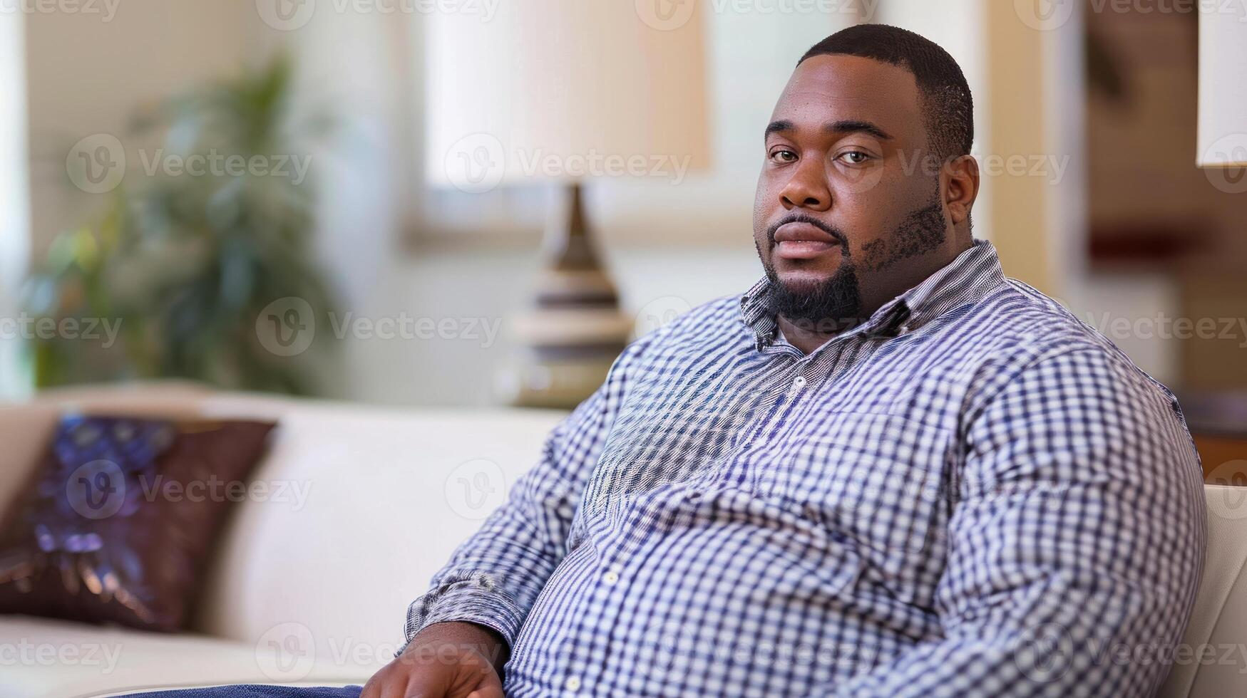 A man relaxing on a couch in a cozy living room photo