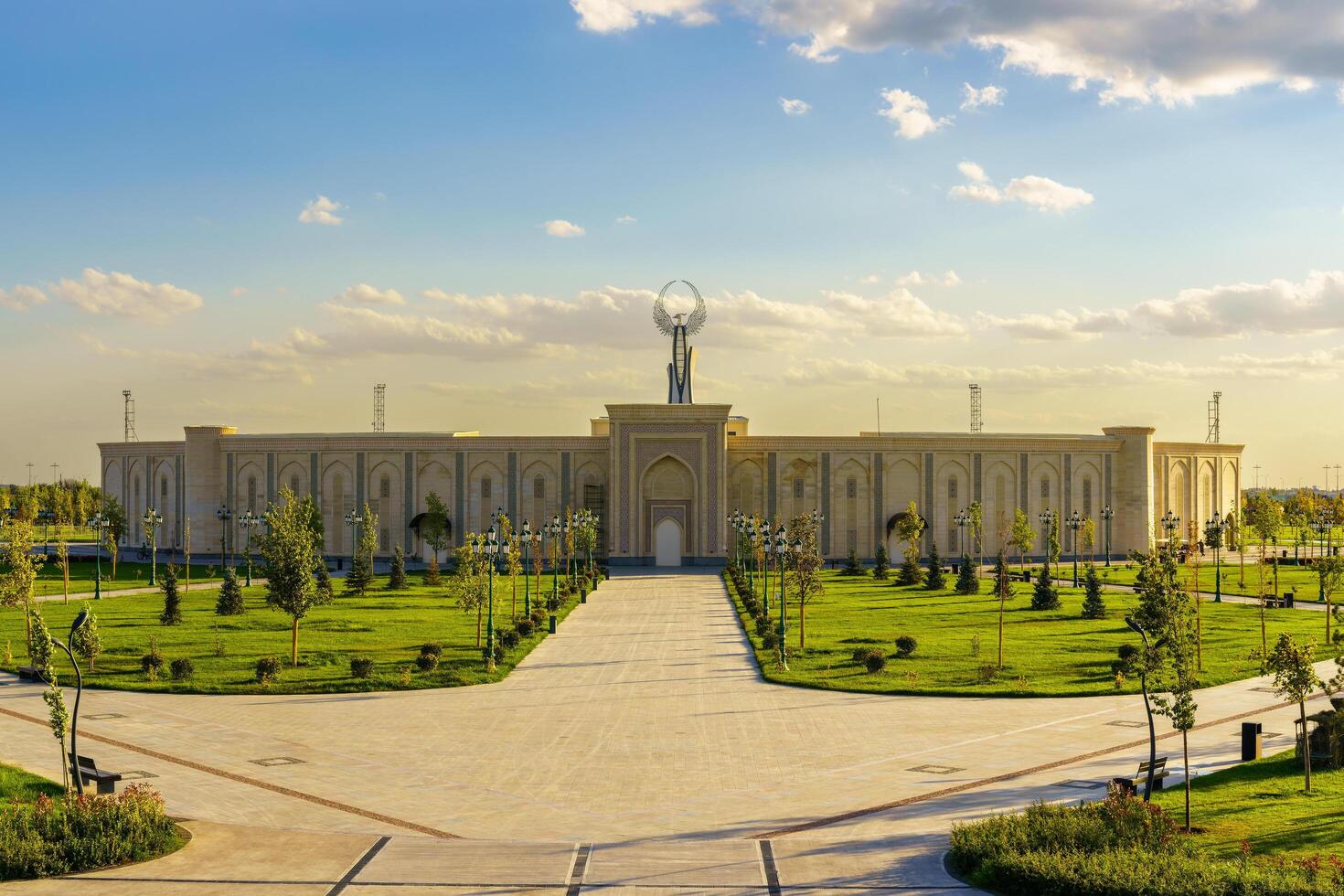 Uzbekistan, Tashkent - October 4, 2023 The territory of the park New Uzbekistan with Monument of Independence in the form of a stele with a Humo bird at sunset. photo