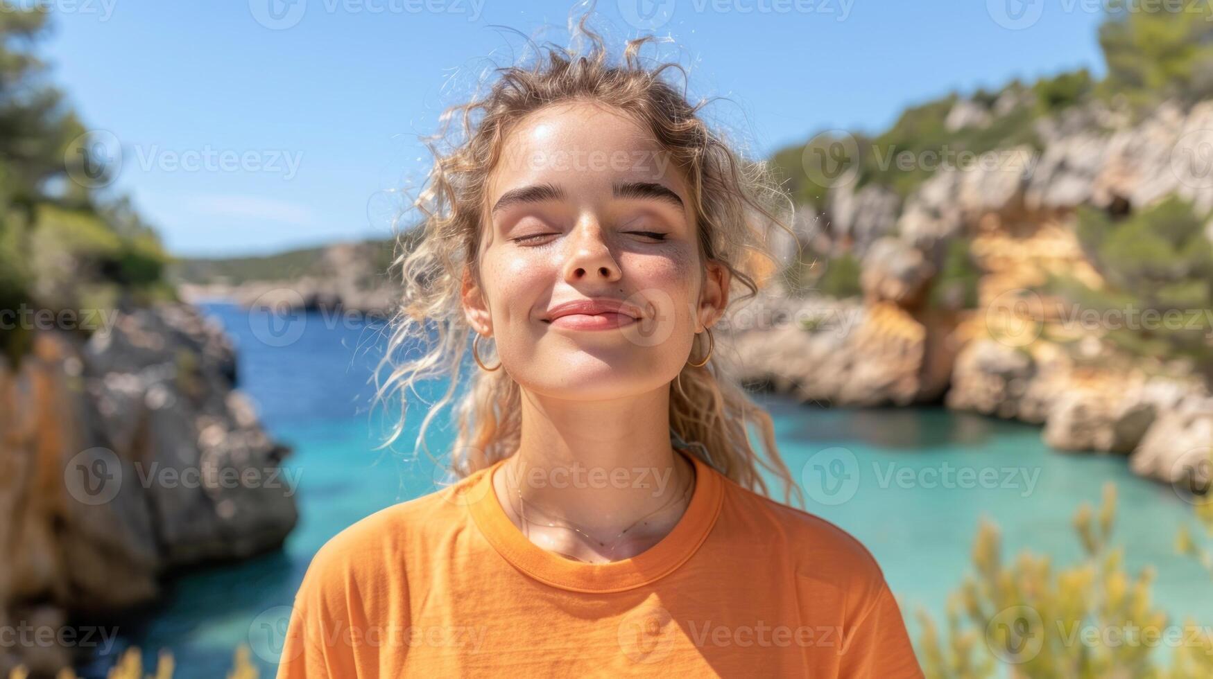 A young girl standing in front of a body of water photo