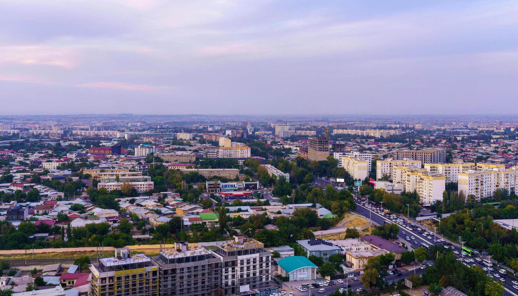 Uzbekistan, Tashkent - September 29, 2023 Top view from the observation deck on the Tashkent TV tower to the central part of the city covered with smog at sunset . Air polution. photo
