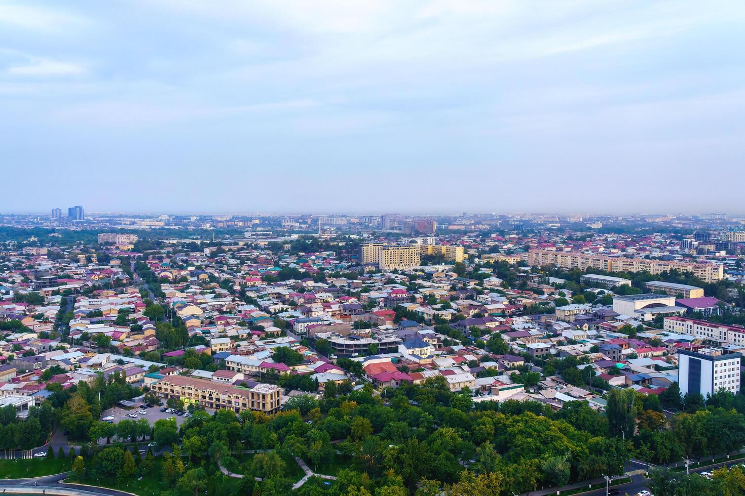 Uzbekistan, Tashkent - September 29, 2023 Top view from the observation deck on the Tashkent TV tower to the central part of the city covered with smog at sunset . Air polution. photo