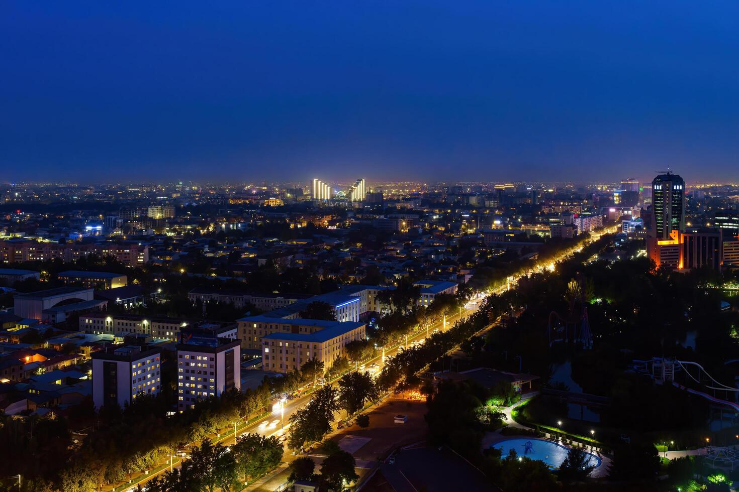 Uzbekistan, Tashkent - September 29, 2023 Top view from the observation deck on the Tashkent TV tower to the central part of the city covered with smog at nighttime . Air polution. photo