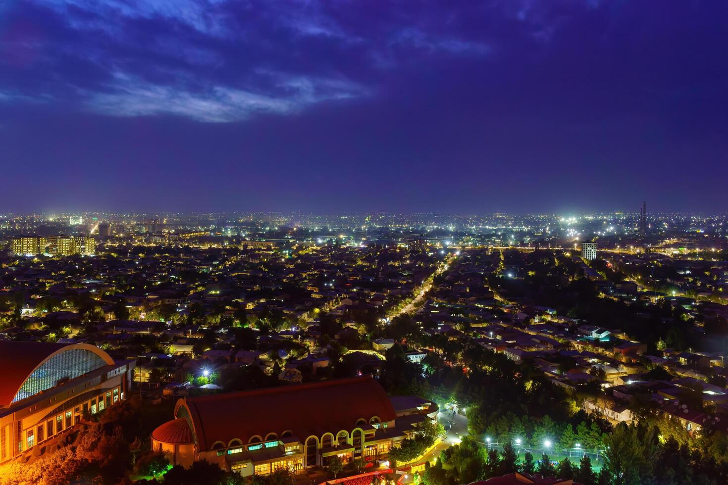 Uzbekistan, Tashkent - September 29, 2023 Top view from the observation deck on the Tashkent TV tower to the central part of the city covered with smog at nighttime . Air polution. photo