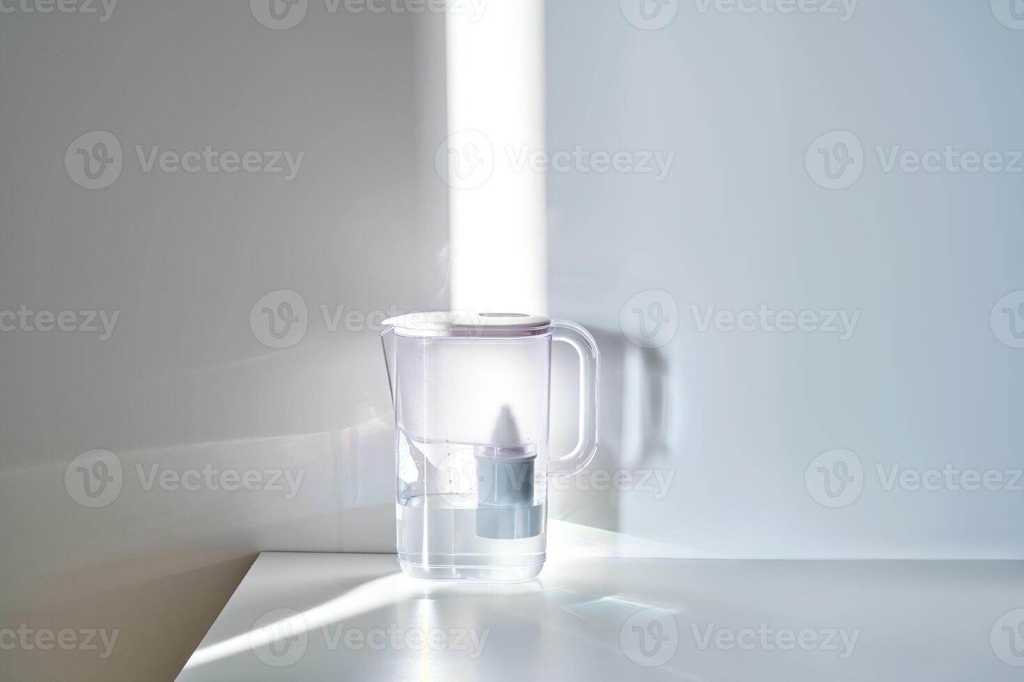 A jug with a water filter in the sun on the table. photo