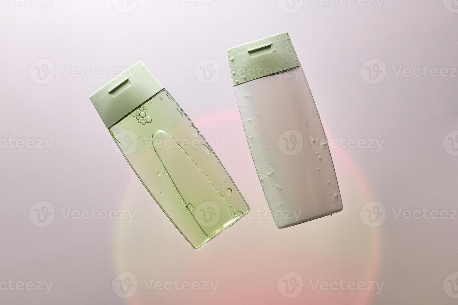 Shampoo and hair conditioner in water on a white background with colored light. photo