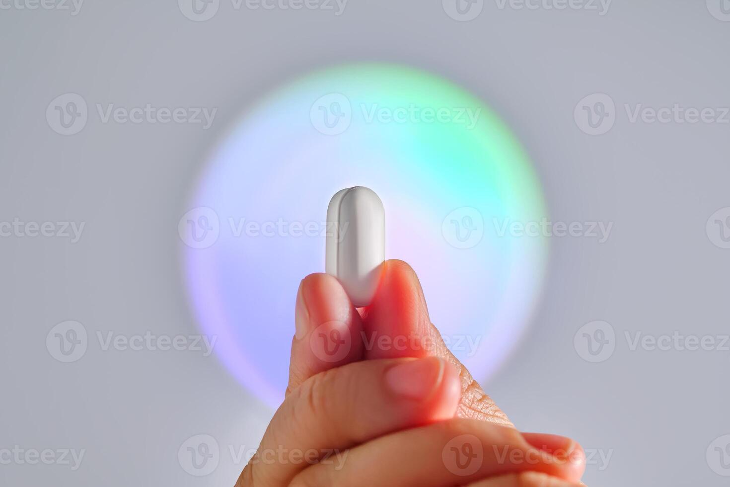Tablet in hand against the background of a glowing circle. photo