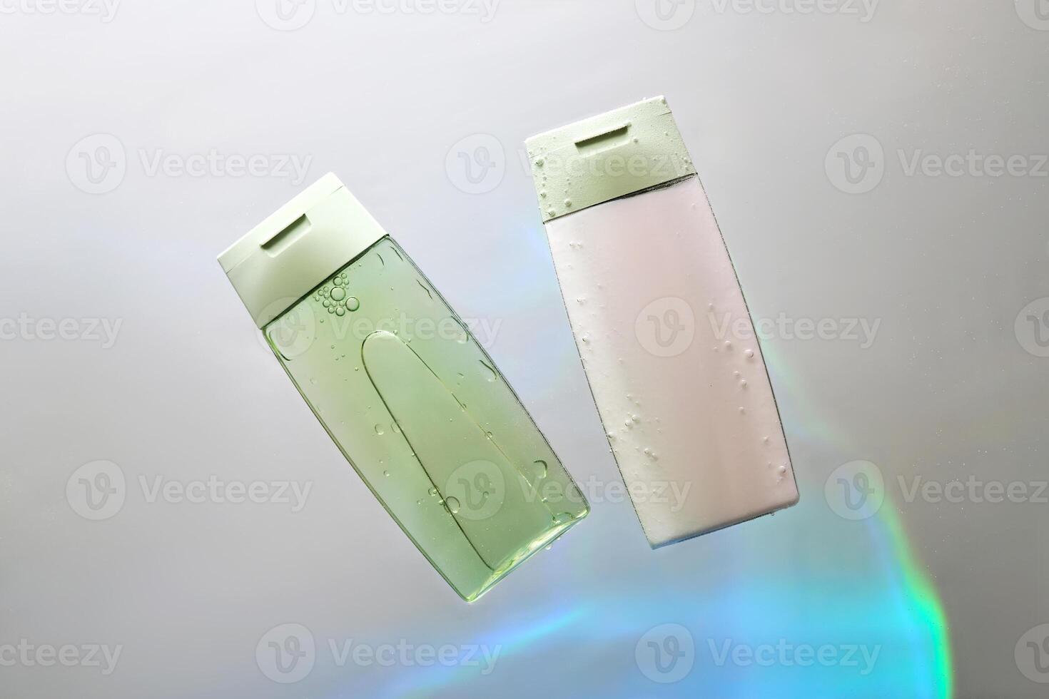 Shampoo and hair conditioner in water on a white background with colored light. photo