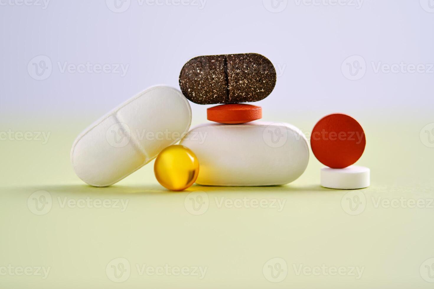 Pills, vitamins and dietary supplements on a green background. photo