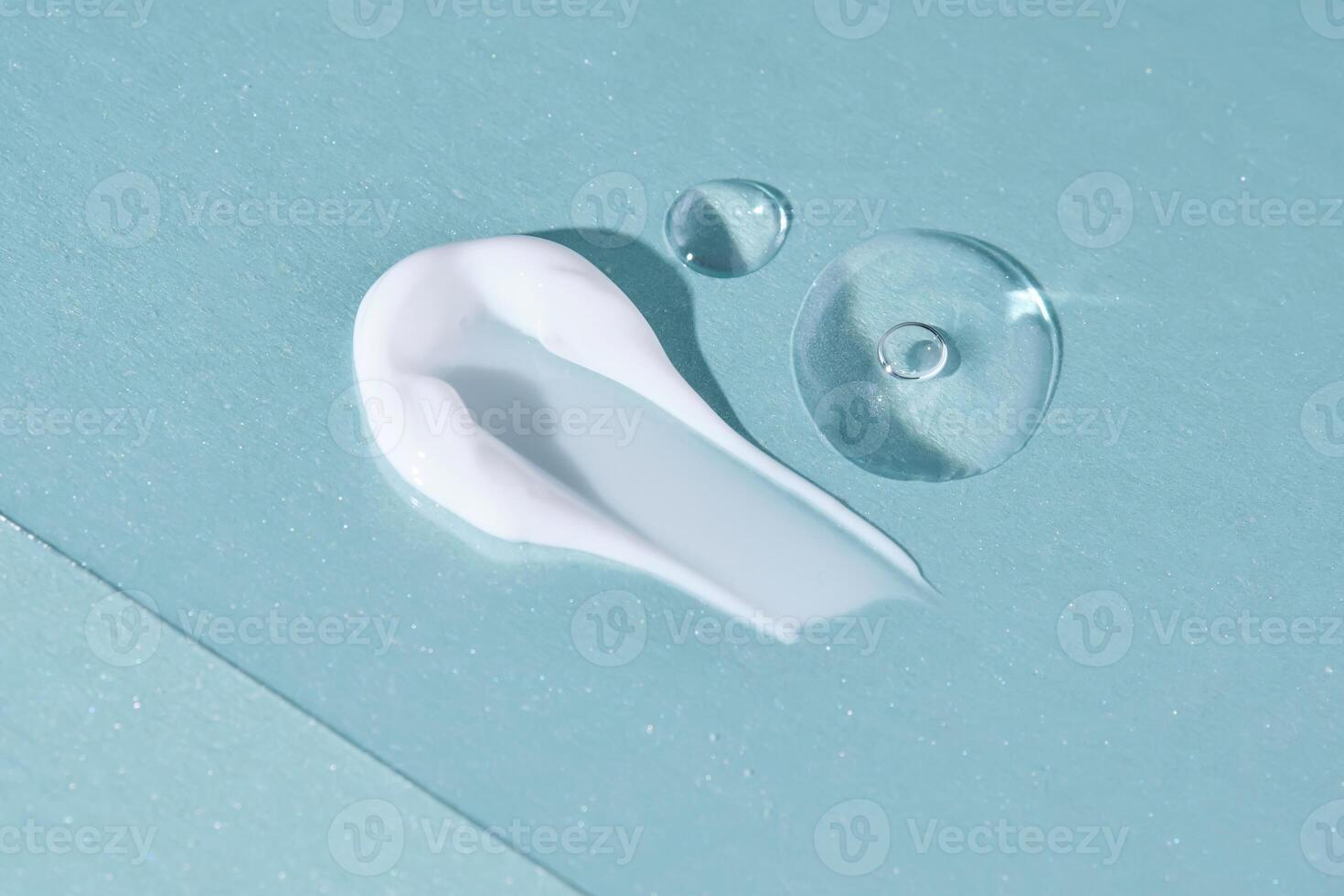 A smear with drops of serum on a blue background. photo