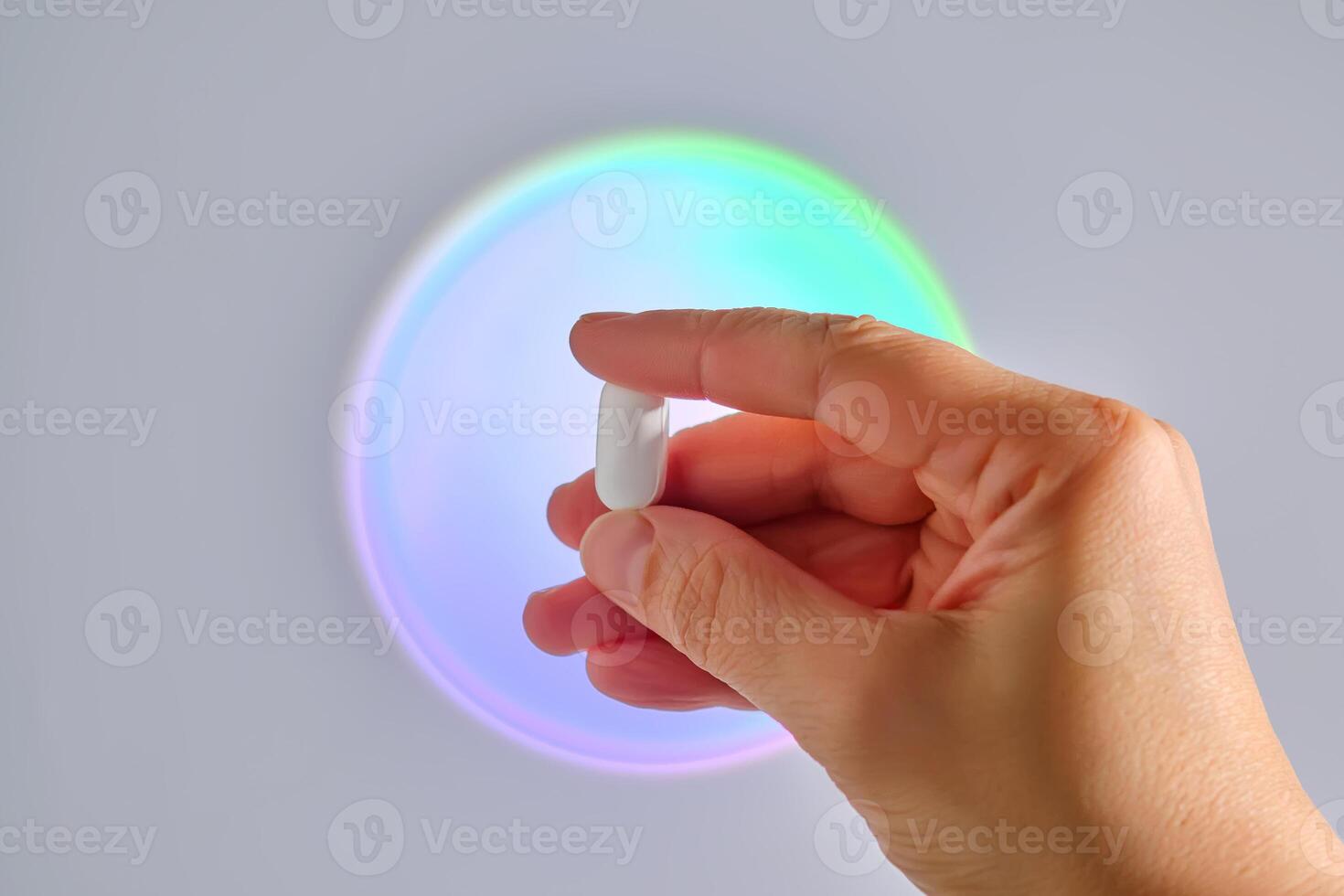 Tablet in hand against the background of a glowing circle. photo