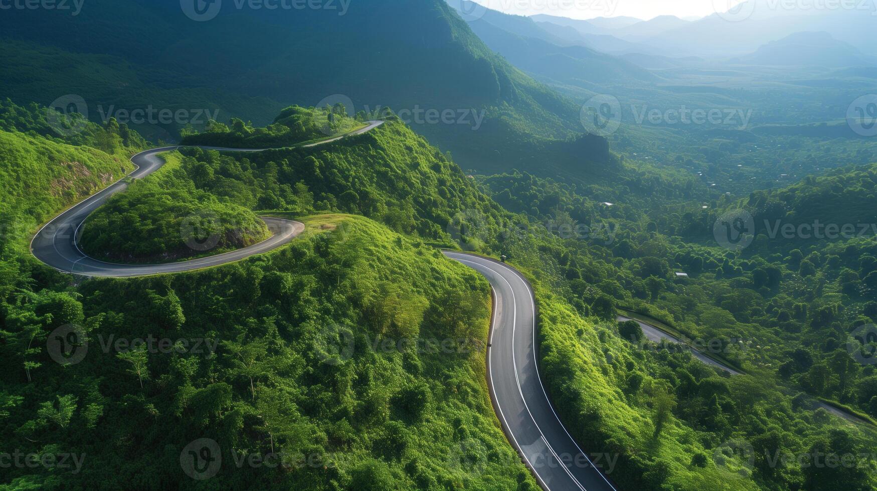 Sunlit Serpentine Road Carving Through Verdant Mountain Hills. photo