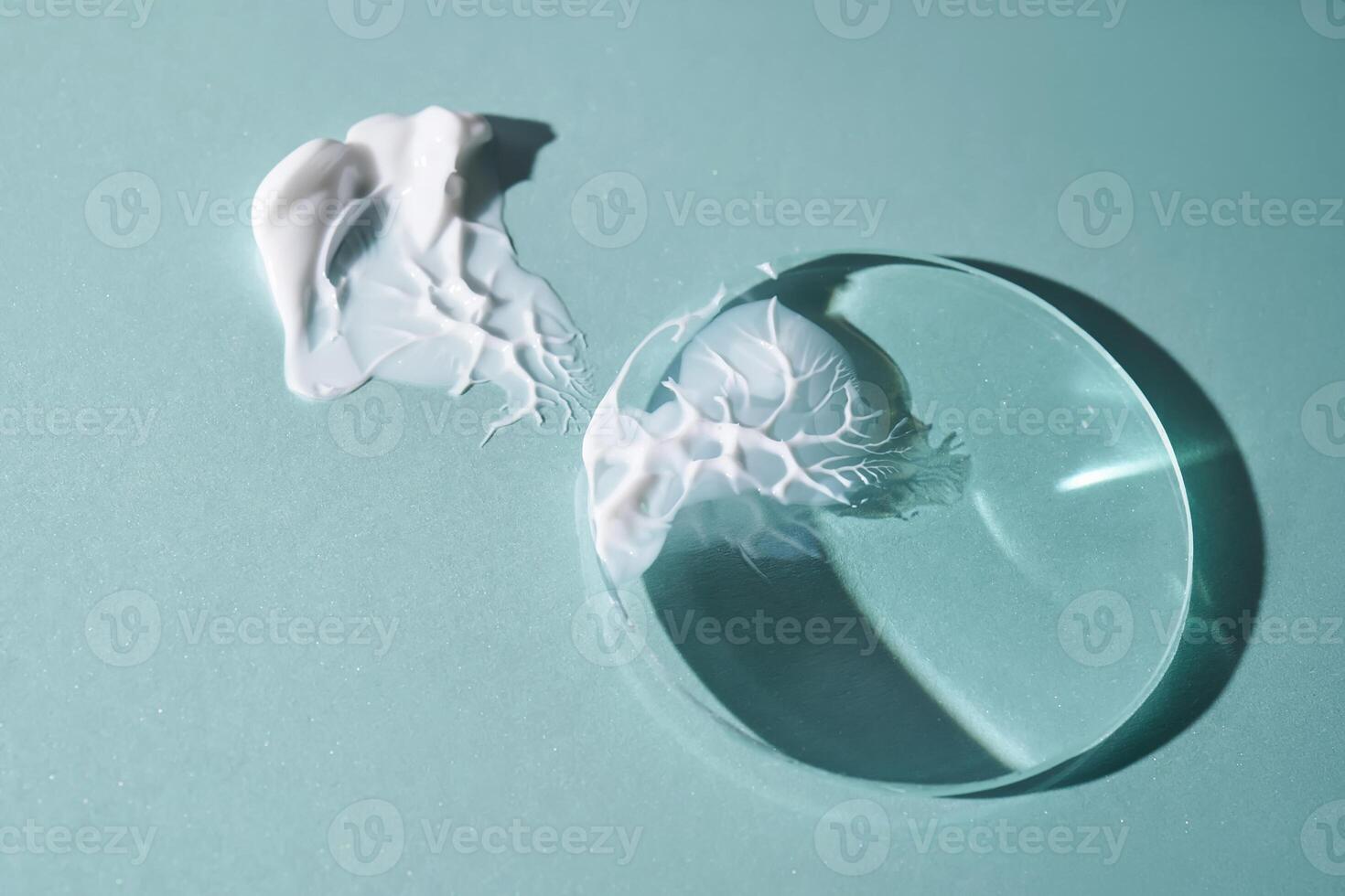 A smear of cream against a background of glass prisms on a blue background. photo